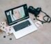A Creative Workspace Featuring Photography Equipment And A Laptop For Digital Editing And Photo Management.